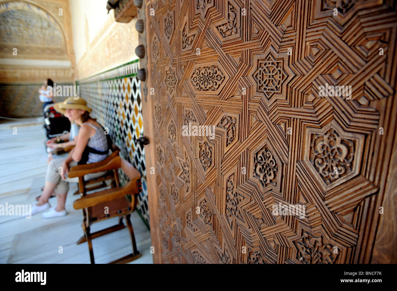 Alhambra Palace - intricate carvings on a heavy wooden door leading into the Comares Palace Stock Photo