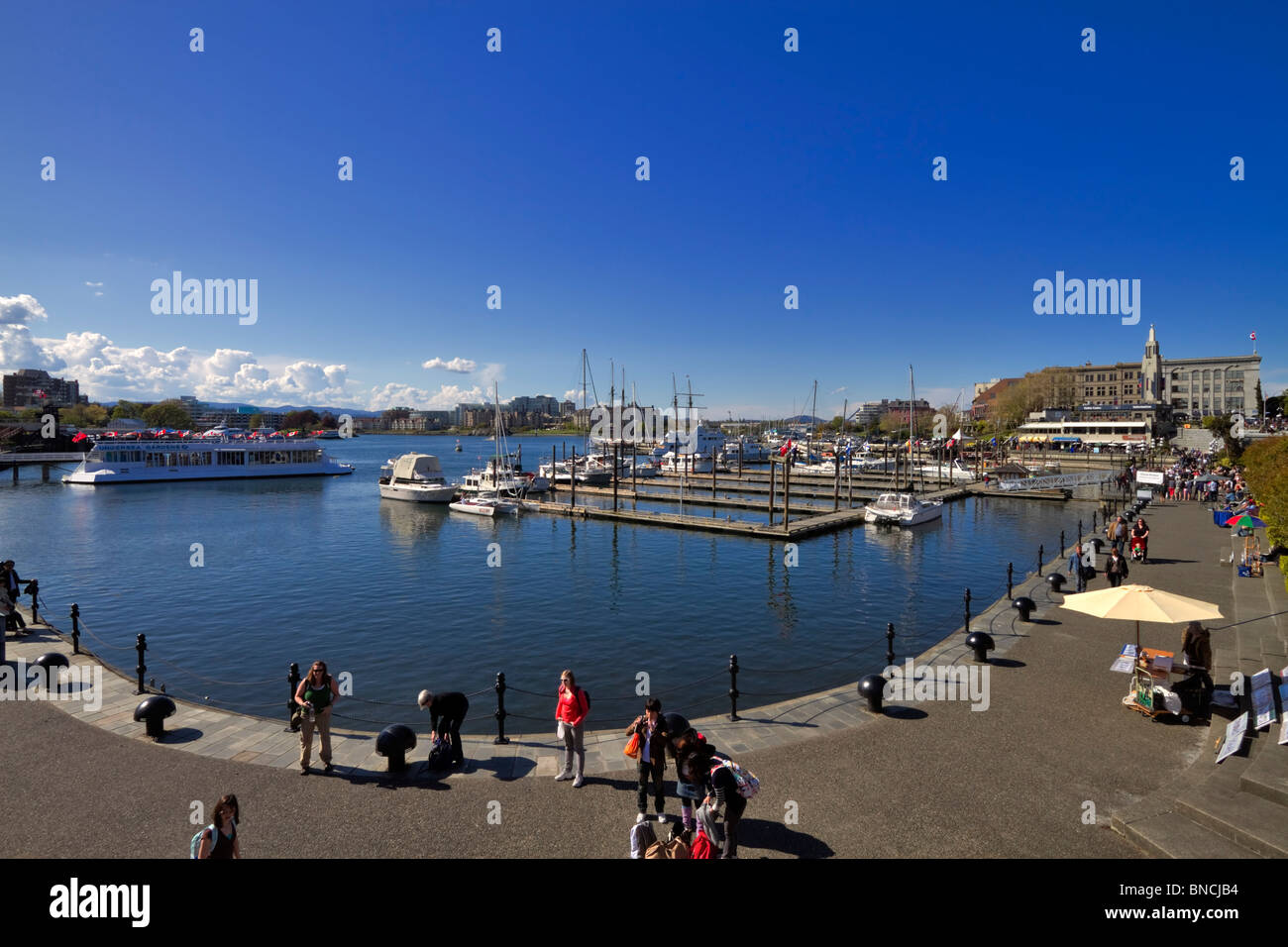 Tourists enjoy spring sunshine in the Inner Harbour, Victoria, British Columbia Stock Photo