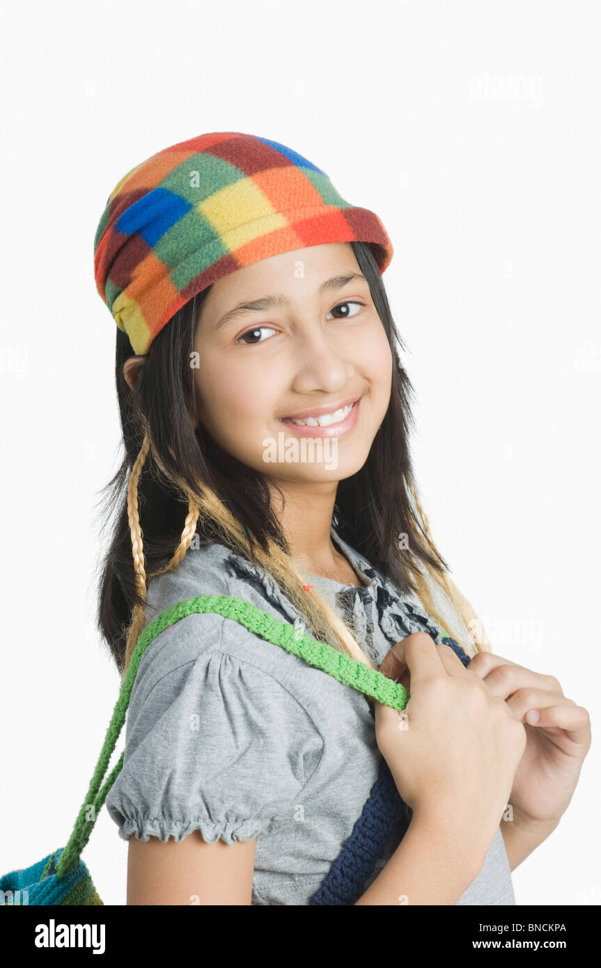 Portrait of a girl holding a backpack and smiling Stock Photo - Alamy