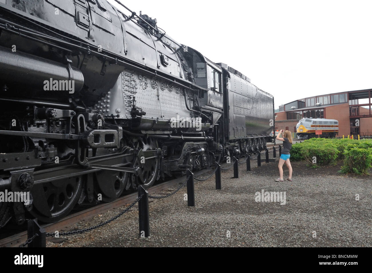 Young woman photographing the Union Pacific Big Boy 4012, Steamtown National Historic Site, Scranton, PA 100710 35567 Stock Photo