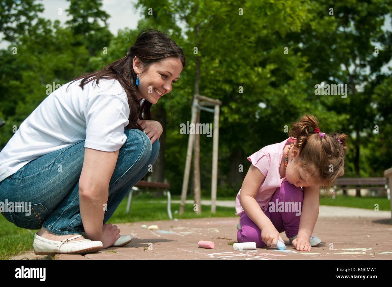 A child has used drawing chaulk to creat art on a playground Stock Photo -  Alamy