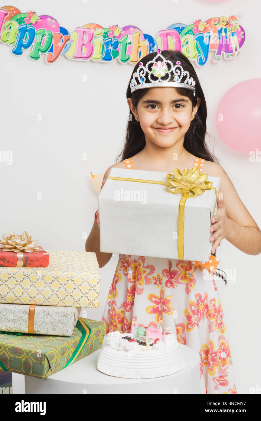 Portrait of a girl holding birthday presents Stock Photo - Alamy