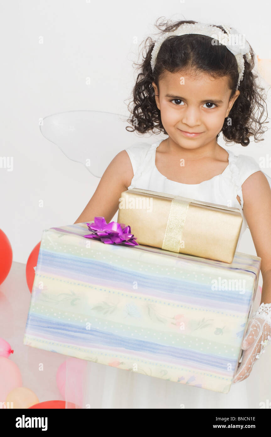 Portrait of a girl holding birthday presents Stock Photo - Alamy