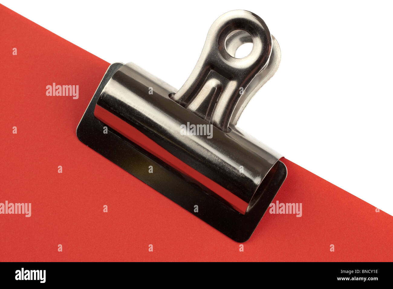 Bulldog clip attached to red card Stock Photo