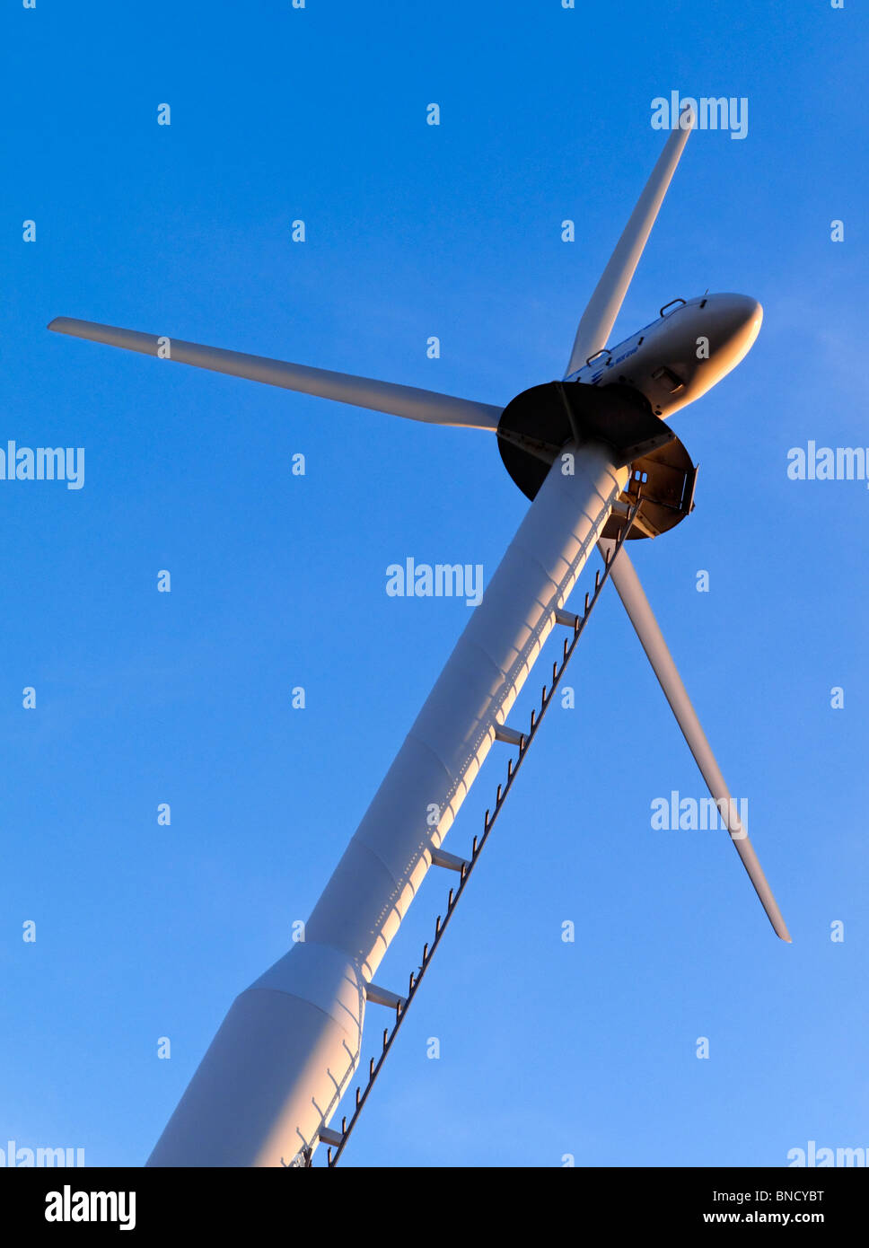 Wind turbine with blue sky behind Stock Photo - Alamy