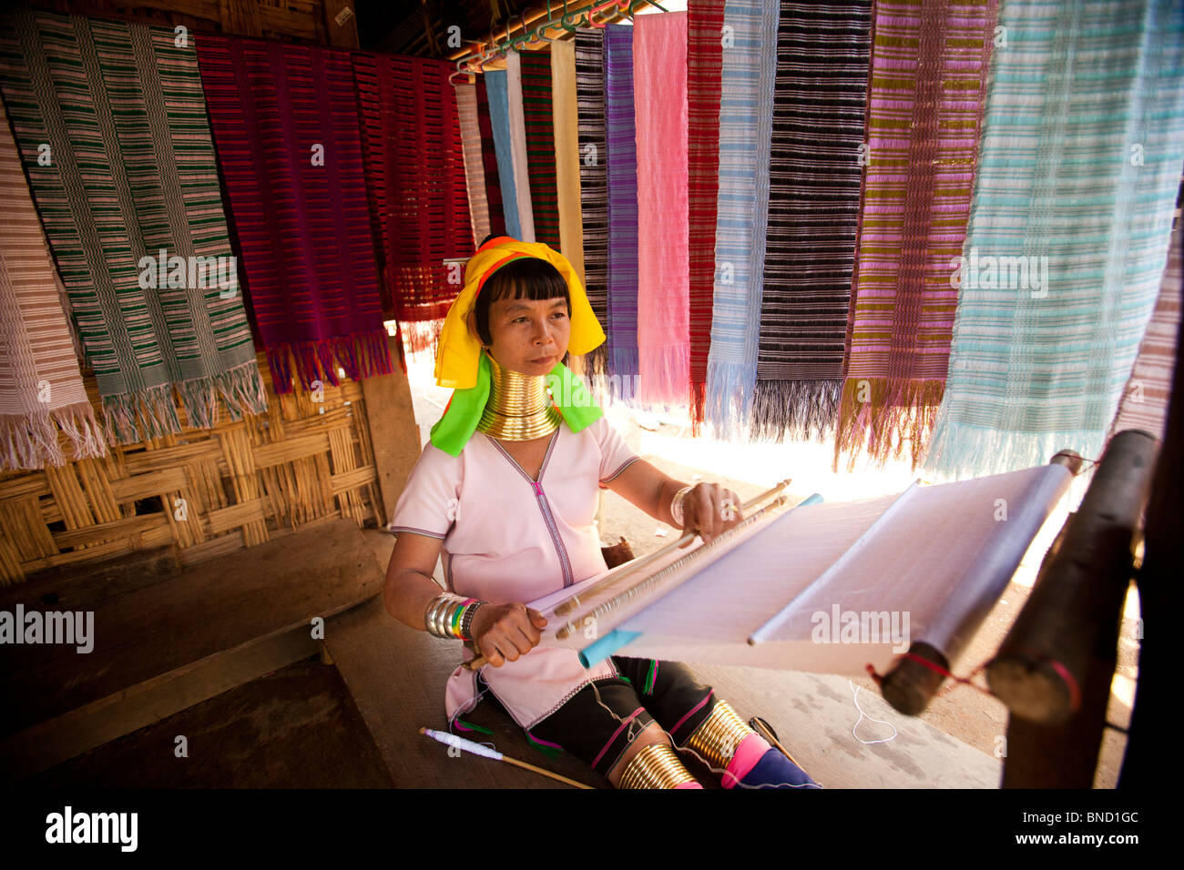 A karen longneck weaves at her home, Mae Hong Son, Northern of Thailand. Stock Photo