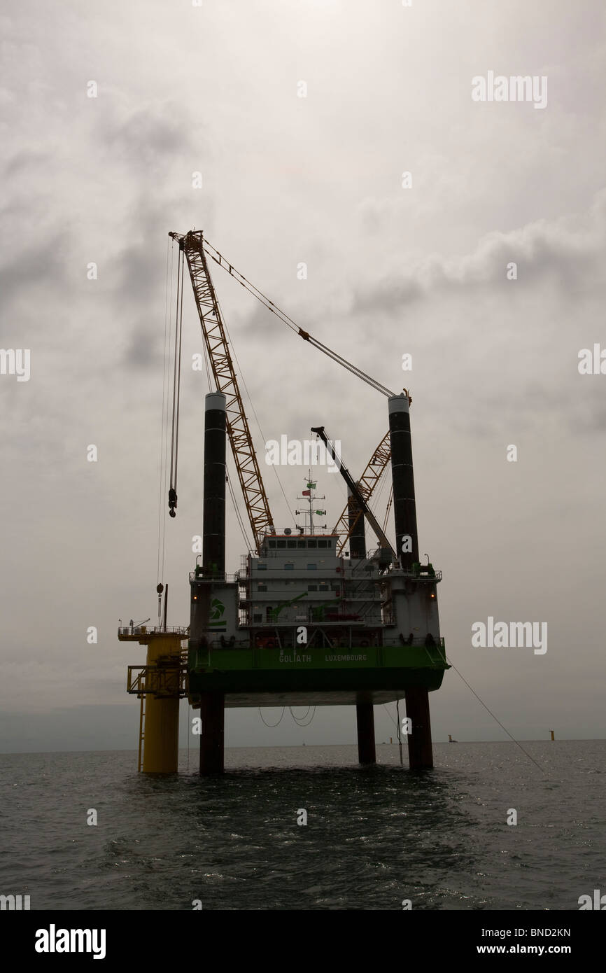 Dong Energy's off shore, Walney Wind Farm using a jack up barge to install the monopiles and transition pieces. Stock Photo