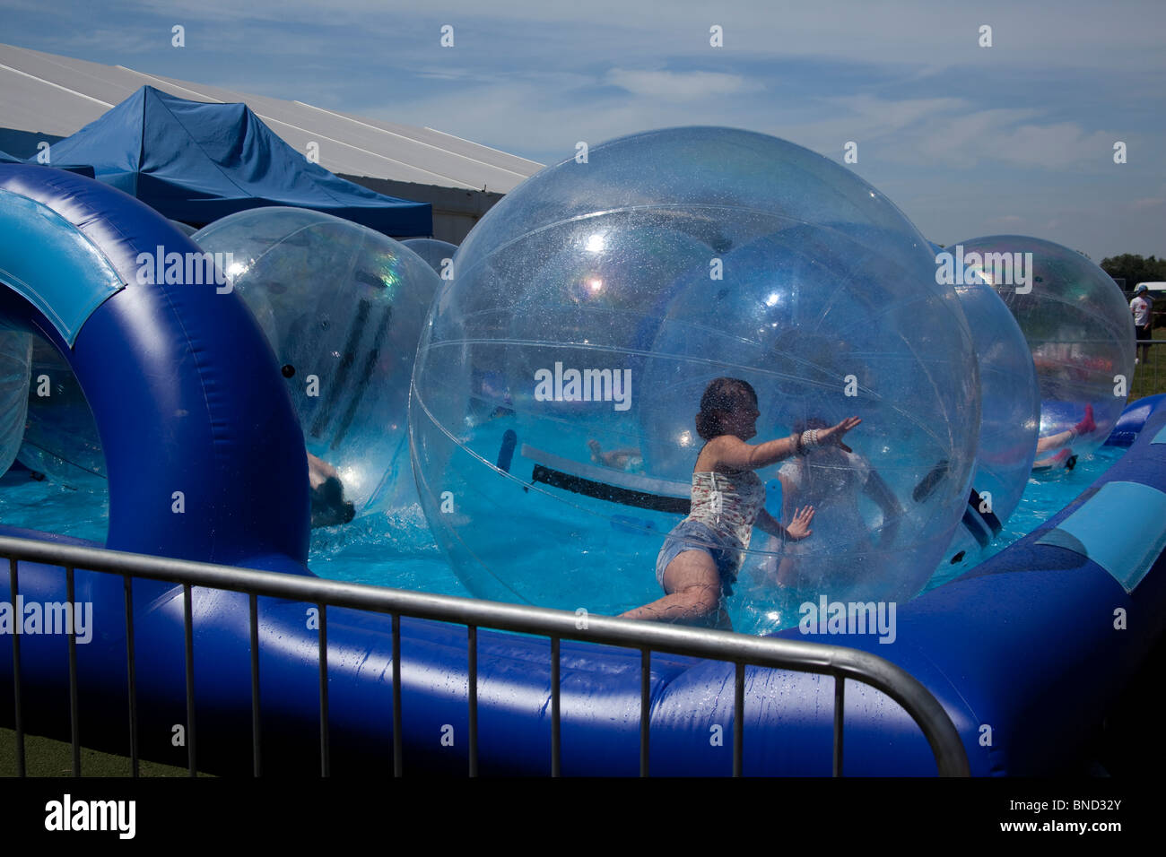 Large plastic bubbles in a pool at Cheshire Show, Knutsford, England