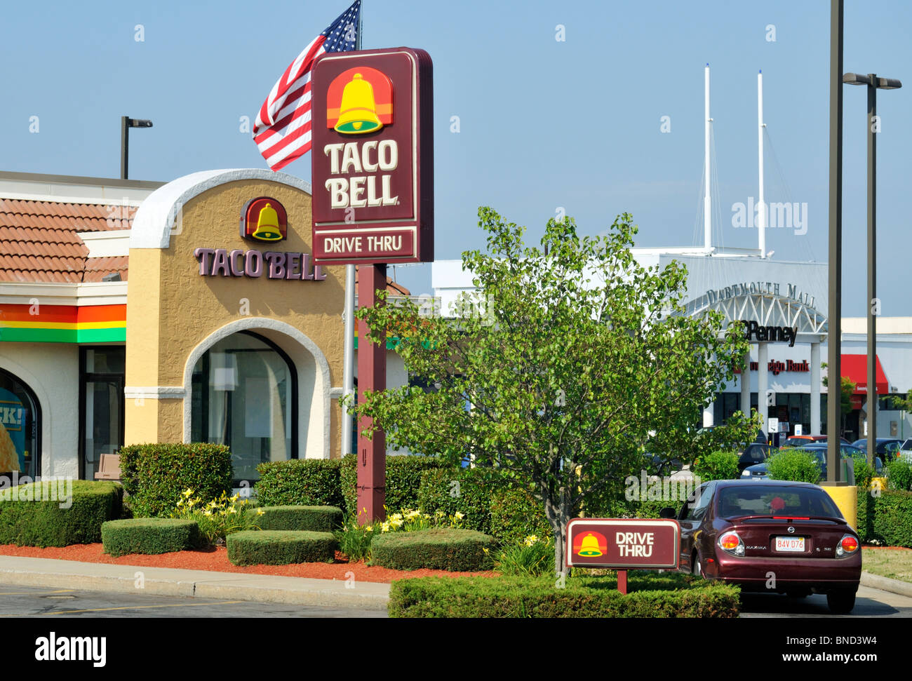 Exterior of Taco Bell fast food restaurant with sign, logo and american flag. USA Stock Photo