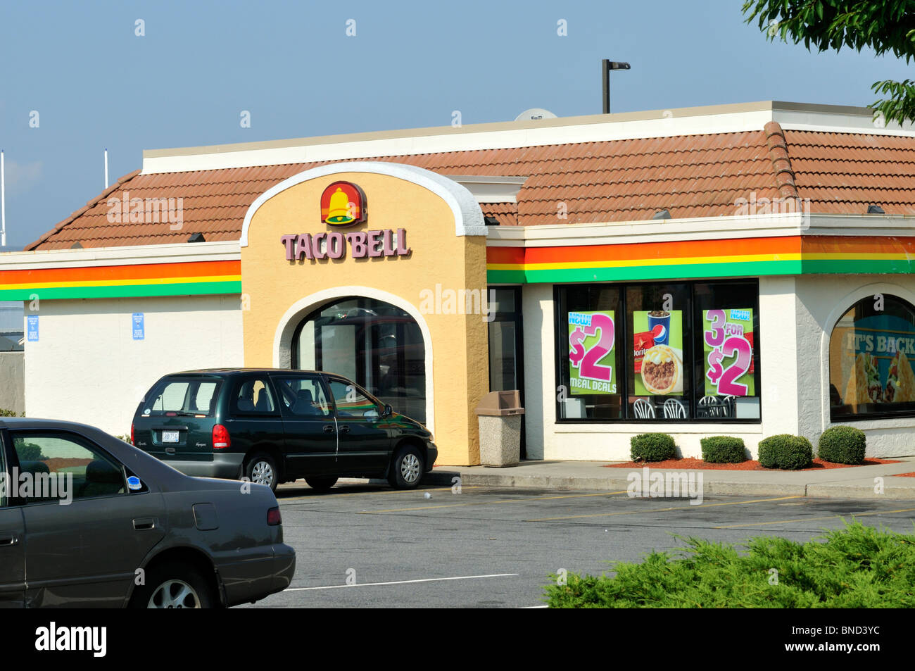 Exterior of Taco Bell fastfood restaurant with  cars in parking lot USA Stock Photo