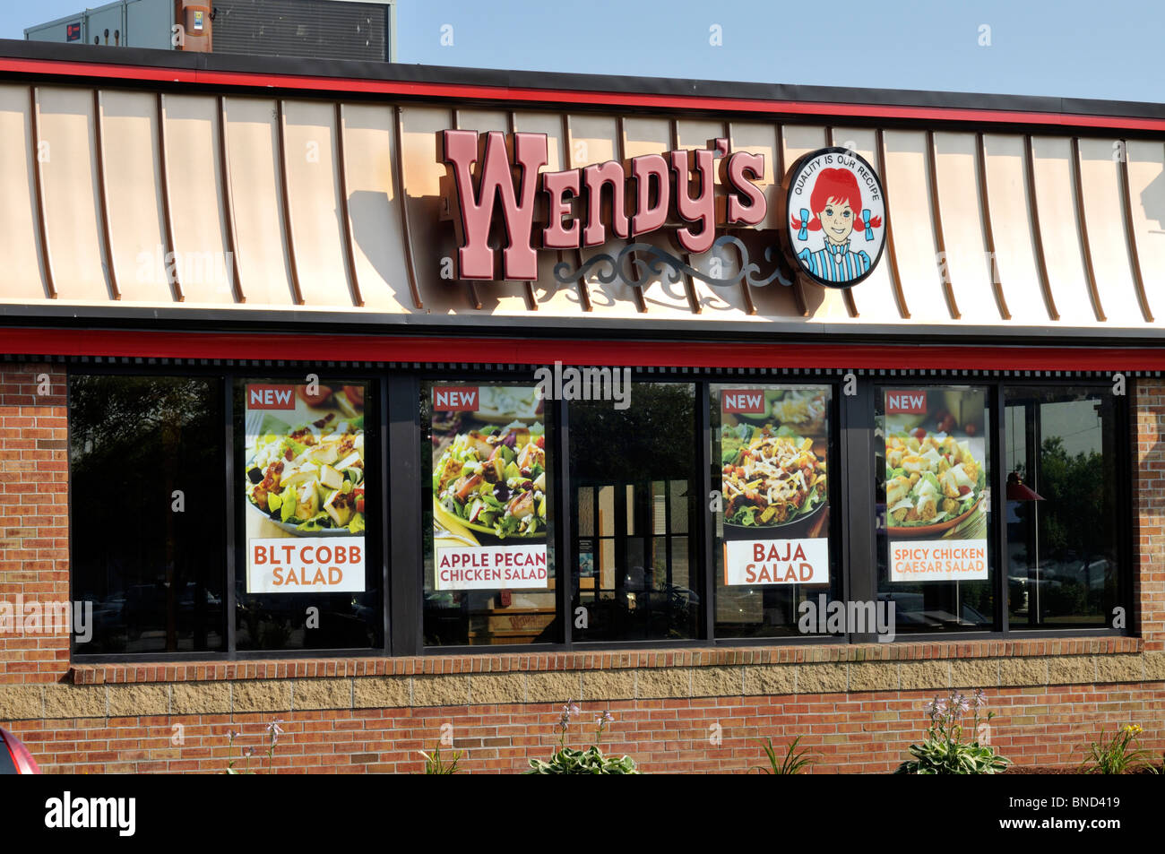 Exterior of Wendys fast food restaurant with logo USA. Stock Photo