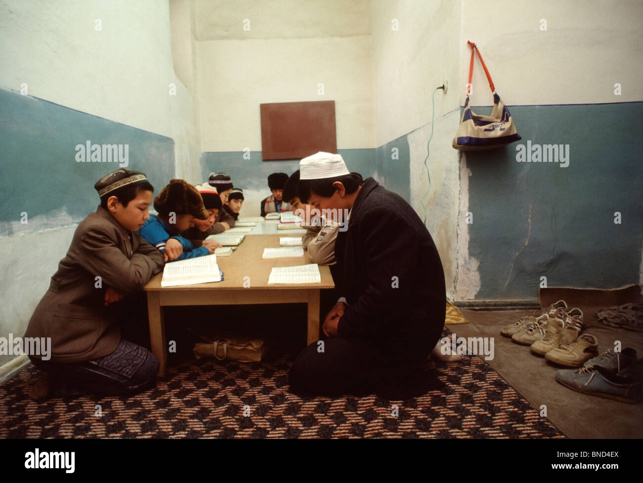 Uzbek schoolboys study the Koran in a basement room in the Kukeldash Medressa in central Tashkent, Uzbekistan Stock Photo
