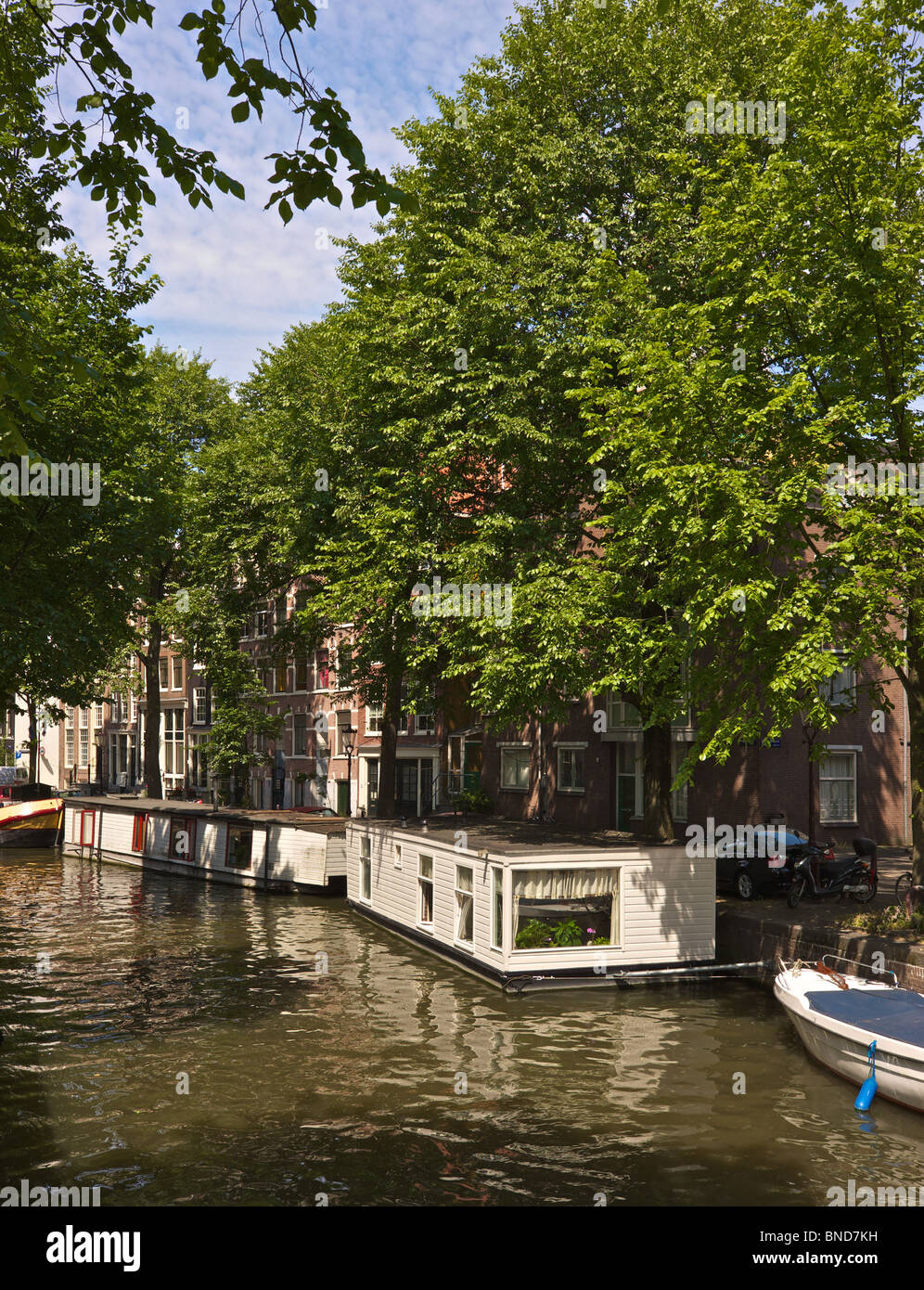 Amsterdam, gabled houses and canal with house boats Stock Photo