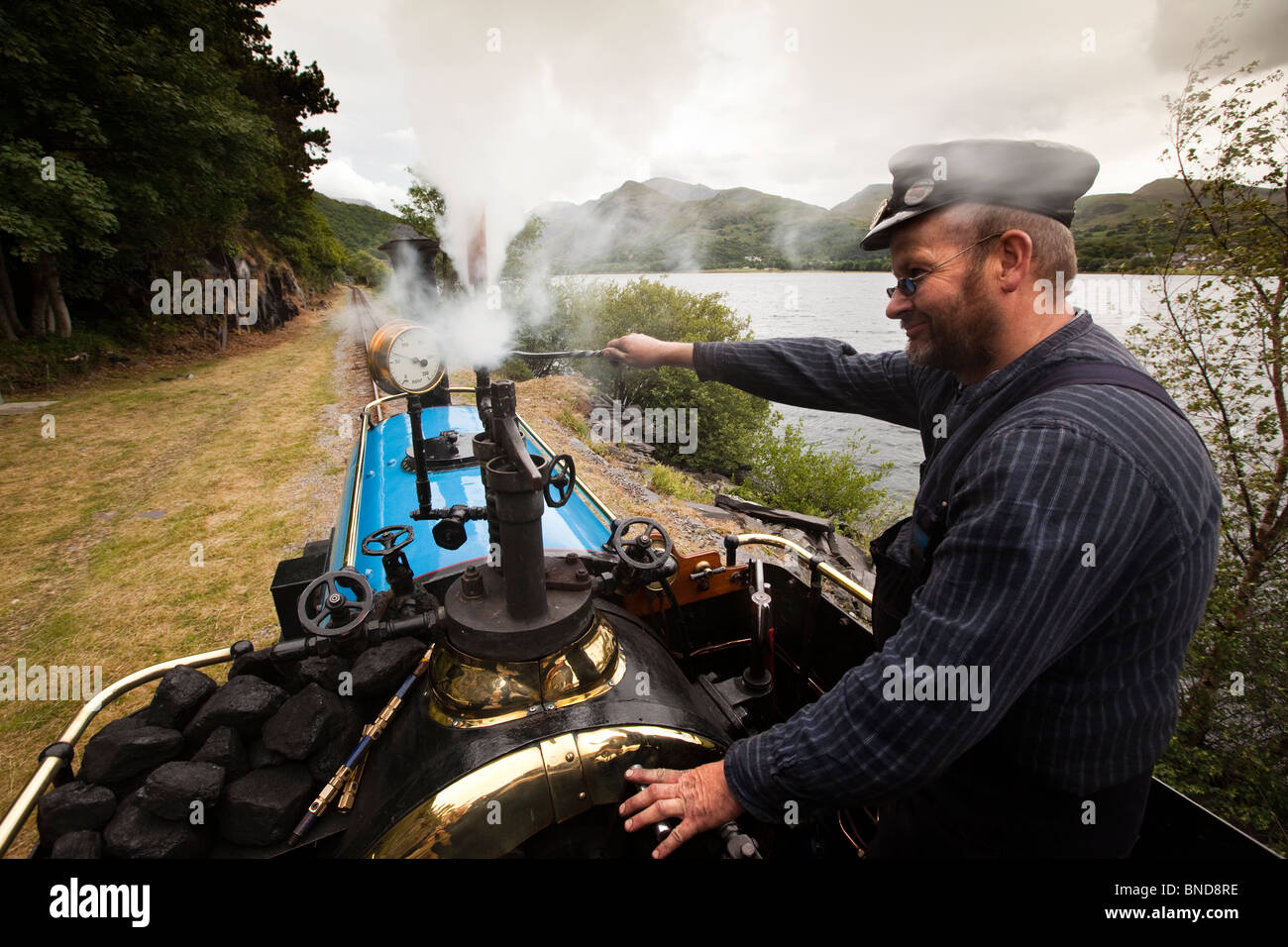 UK, Wales, Snowdonia, Llanberis, Lake Railway, steam train driver’s view from footplate passing Llyn Padarn Stock Photo