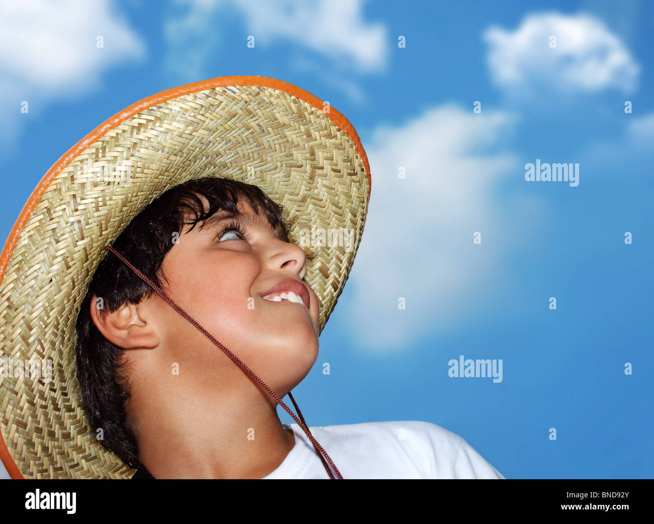 Portrait of a young beautiful boy over blue sky Stock Photo - Alamy