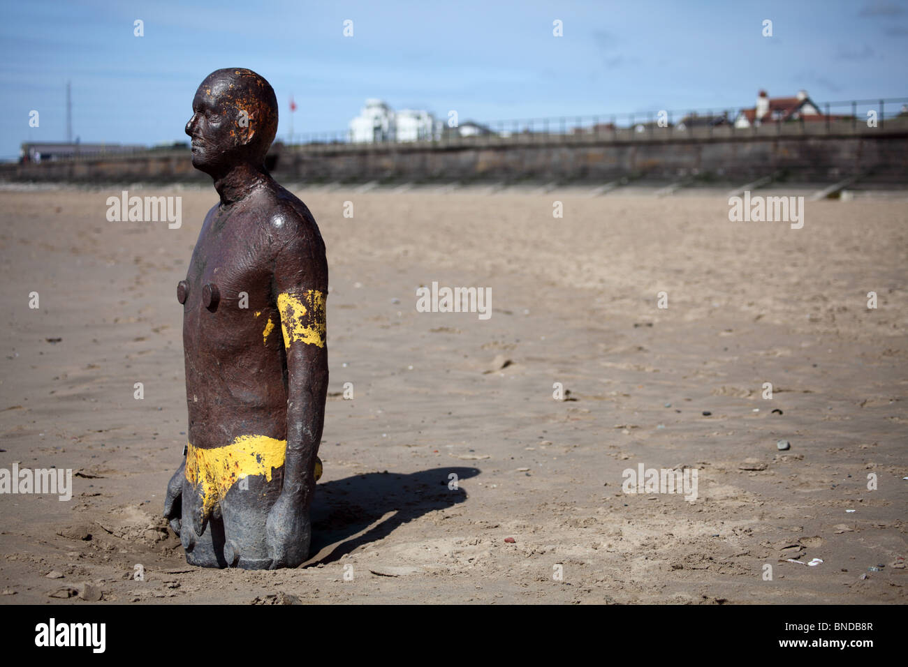 Partly buried cast-iron sculpture Antony Gormley's Another place, Crosby beach, Sefton Stock Photo