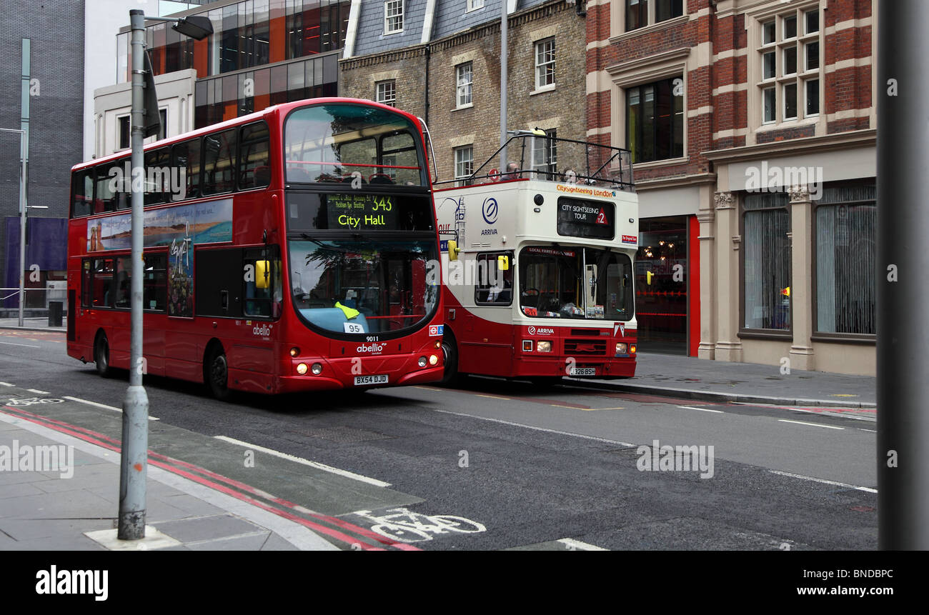 Red London bus and tourist bus on London Street Stock Photo