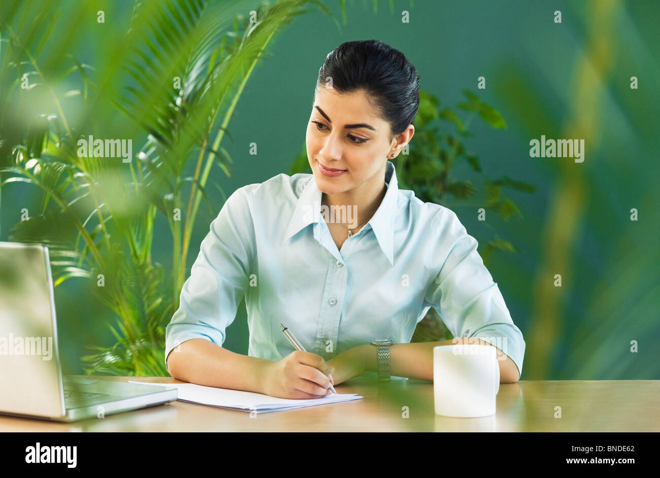 Businesswoman working in an office Stock Photo - Alamy