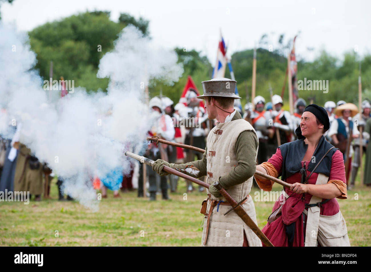 Medieval male gunner firing a handgonne on the battlefield at the Tewkesbury medieval festival 2010. Gloucestershire England Stock Photo