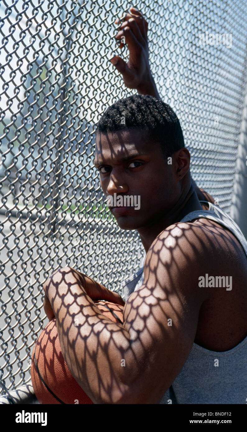 Person at chainlink fence hi-res stock photography and images - Alamy