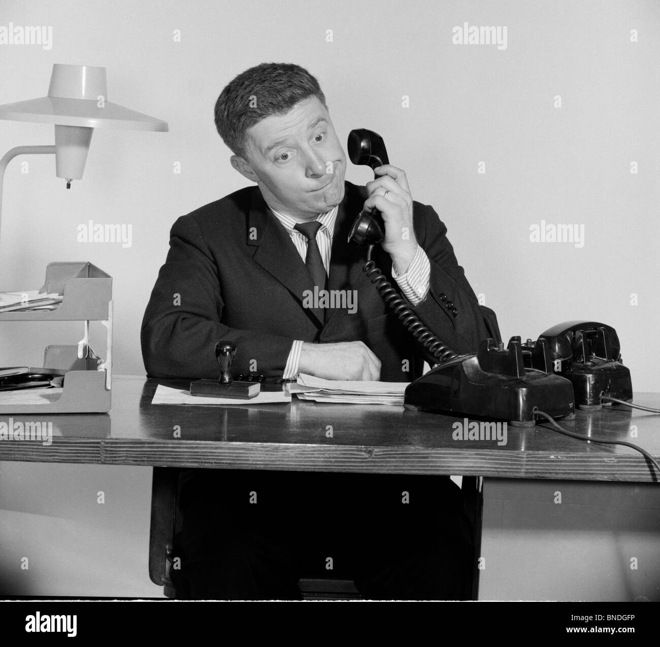 Businessman using a telephone in an office Stock Photo