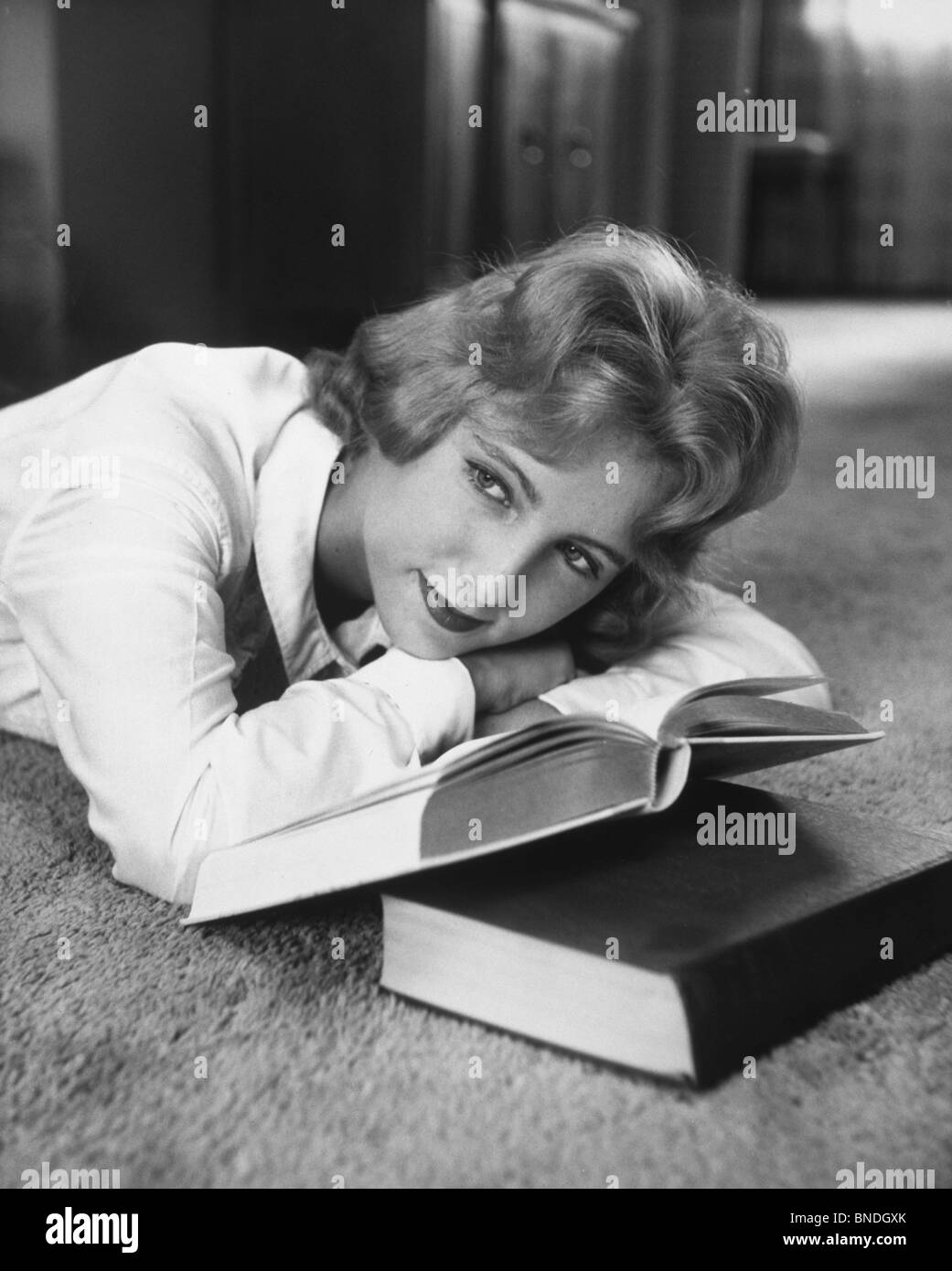 Teenage girl resting her head on her hands Stock Photo - Alamy