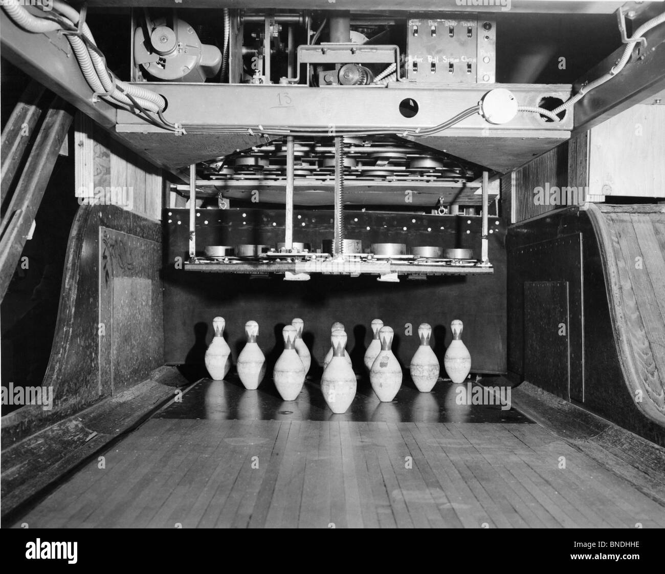 Machinery and bowling pins at the end of a lane Stock Photo