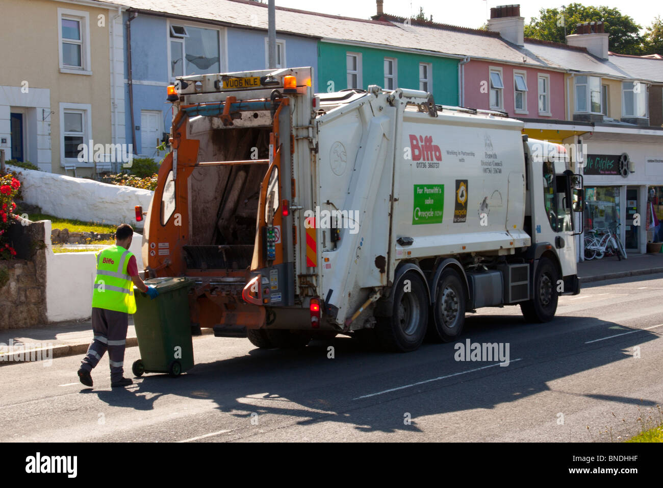 refuge collection in Hayle, Cornwall, England. Dustman collecting rubbish and recycling in dust cart Stock Photo
