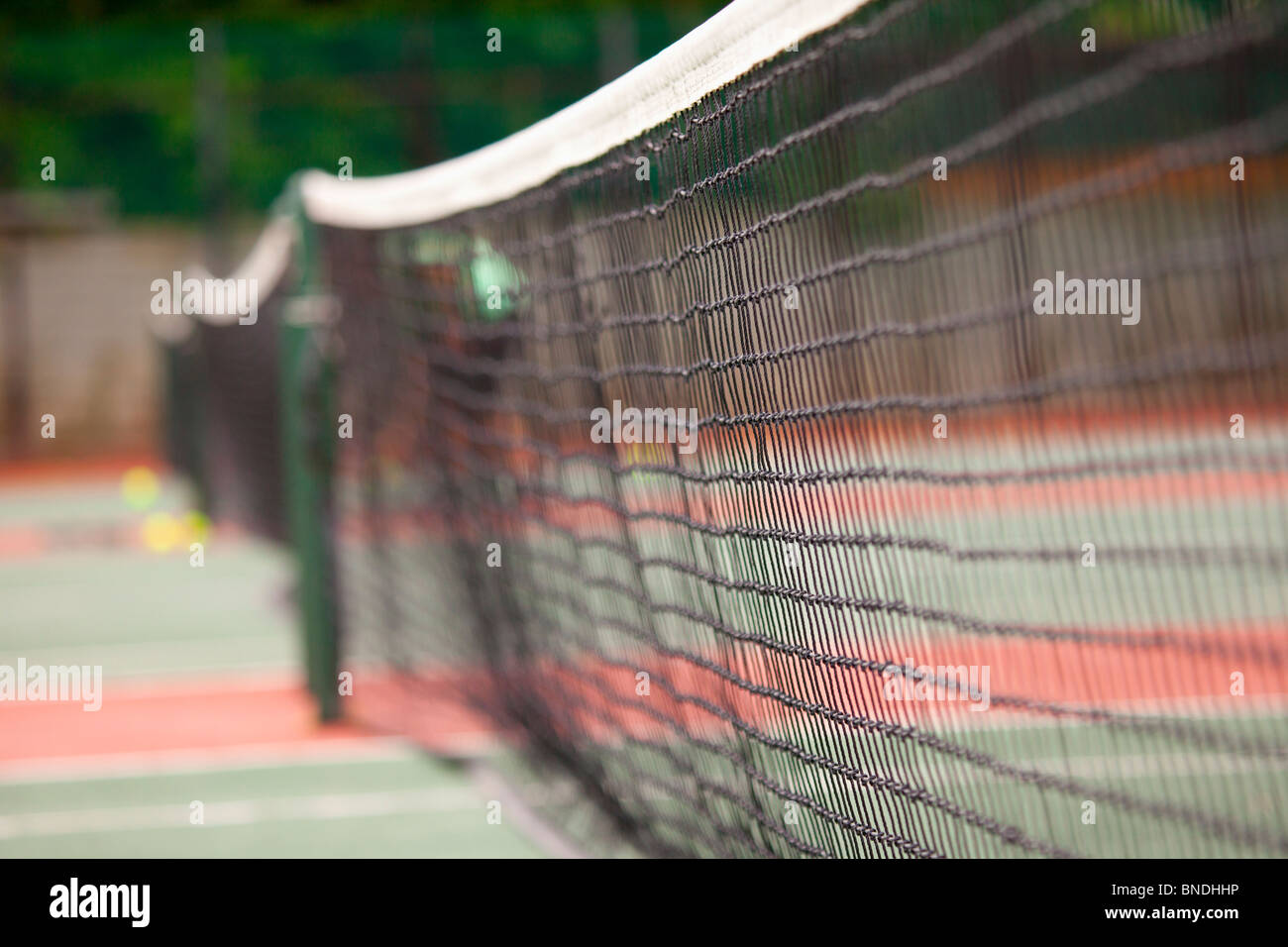 View across the net of tennis courts on a summers day Stock Photo