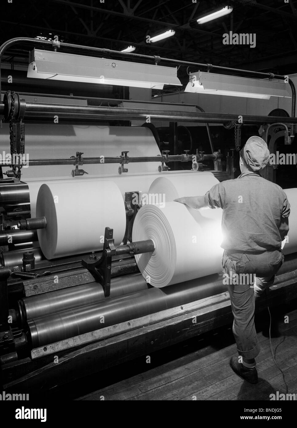 Rear view of a man working in a paper mill Stock Photo