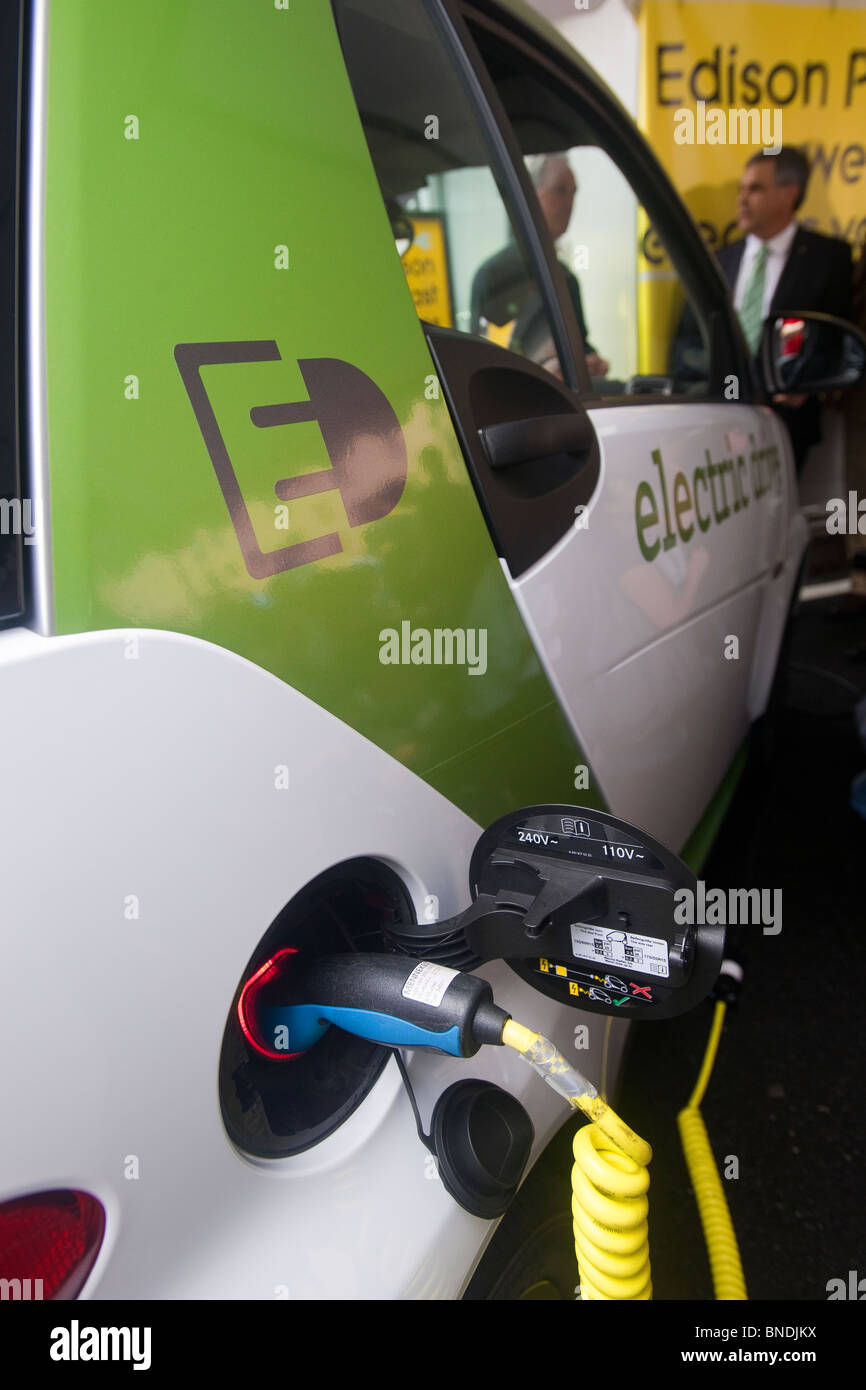 A Smart USA SmartCar is charged at a public electric vehicle charging