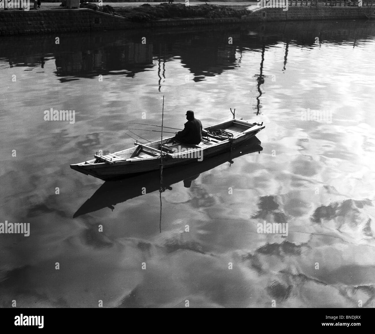 Man sitting on fishing boat Black and White Stock Photos & Images - Alamy