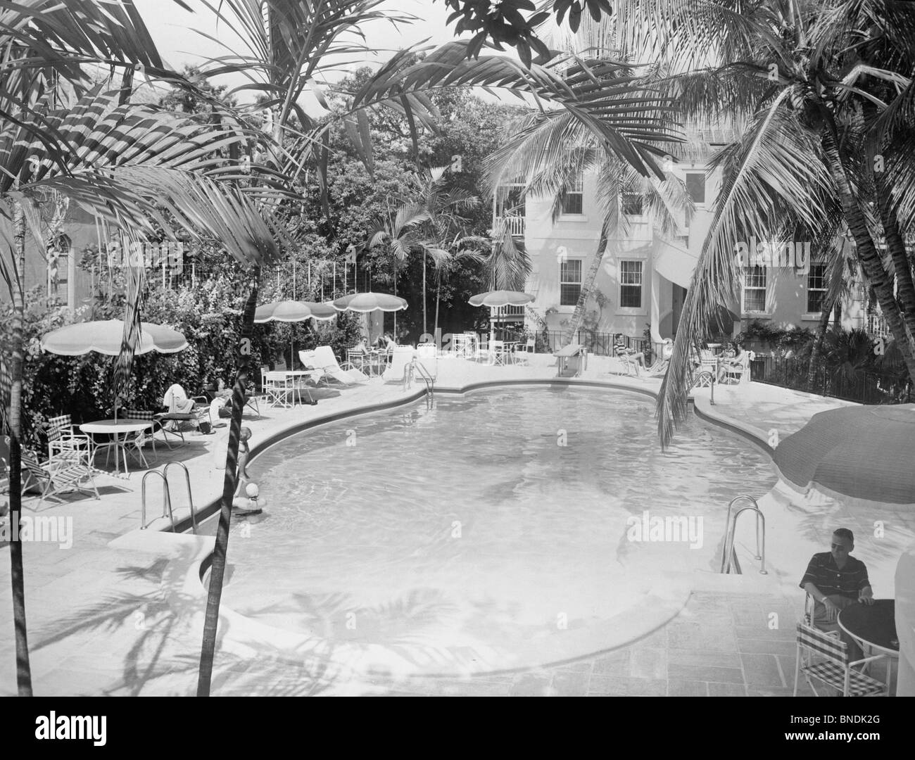 High angle view of a tourist sitting near a swimming pool, Royal Victoria Hotel, Nassau, Bahamas Stock Photo