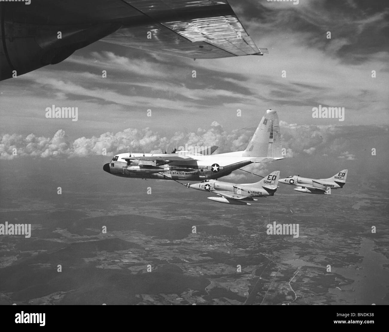 Military tanker airplane refueling a fighter plane in flight, 67T, Lockheed GV-1 Hercules, Refuel Tanker, US Marine Corps Stock Photo