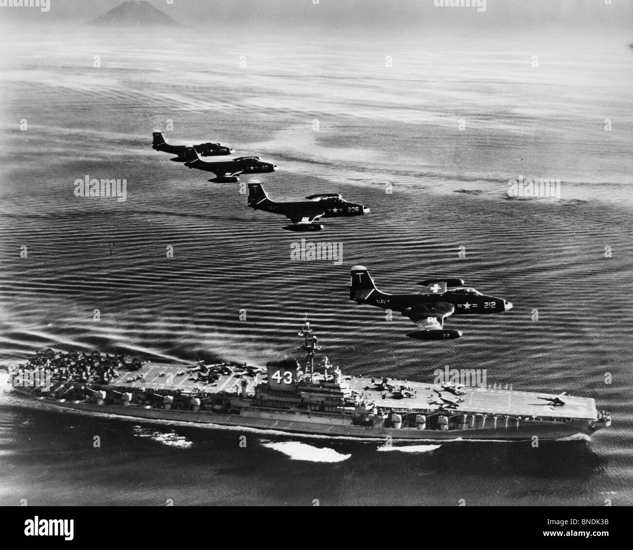 High angle view of four fighter planes flying over an aircraft carrier, US Navy Banshees, USS Coral Sea (CV-43) Stock Photo