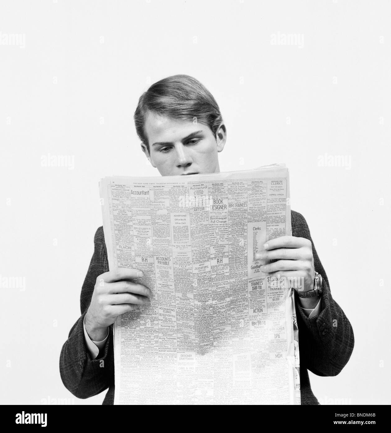 Close-up of a businessman reading help wanted ads Stock Photo