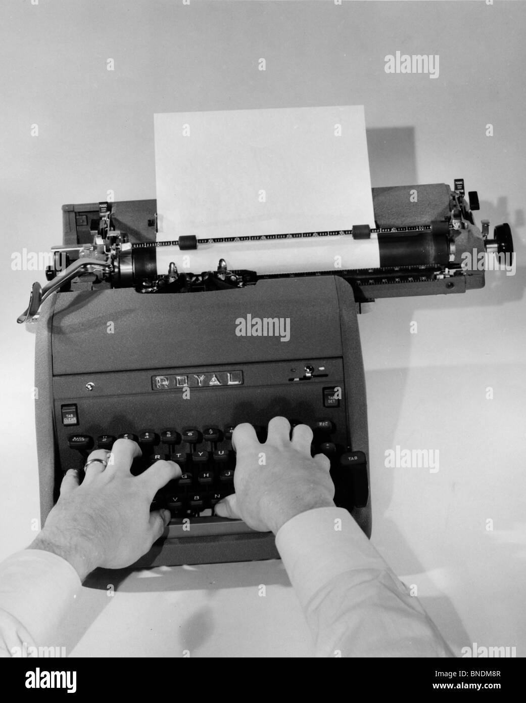 Close-up of a person typing on a typewriter Stock Photo