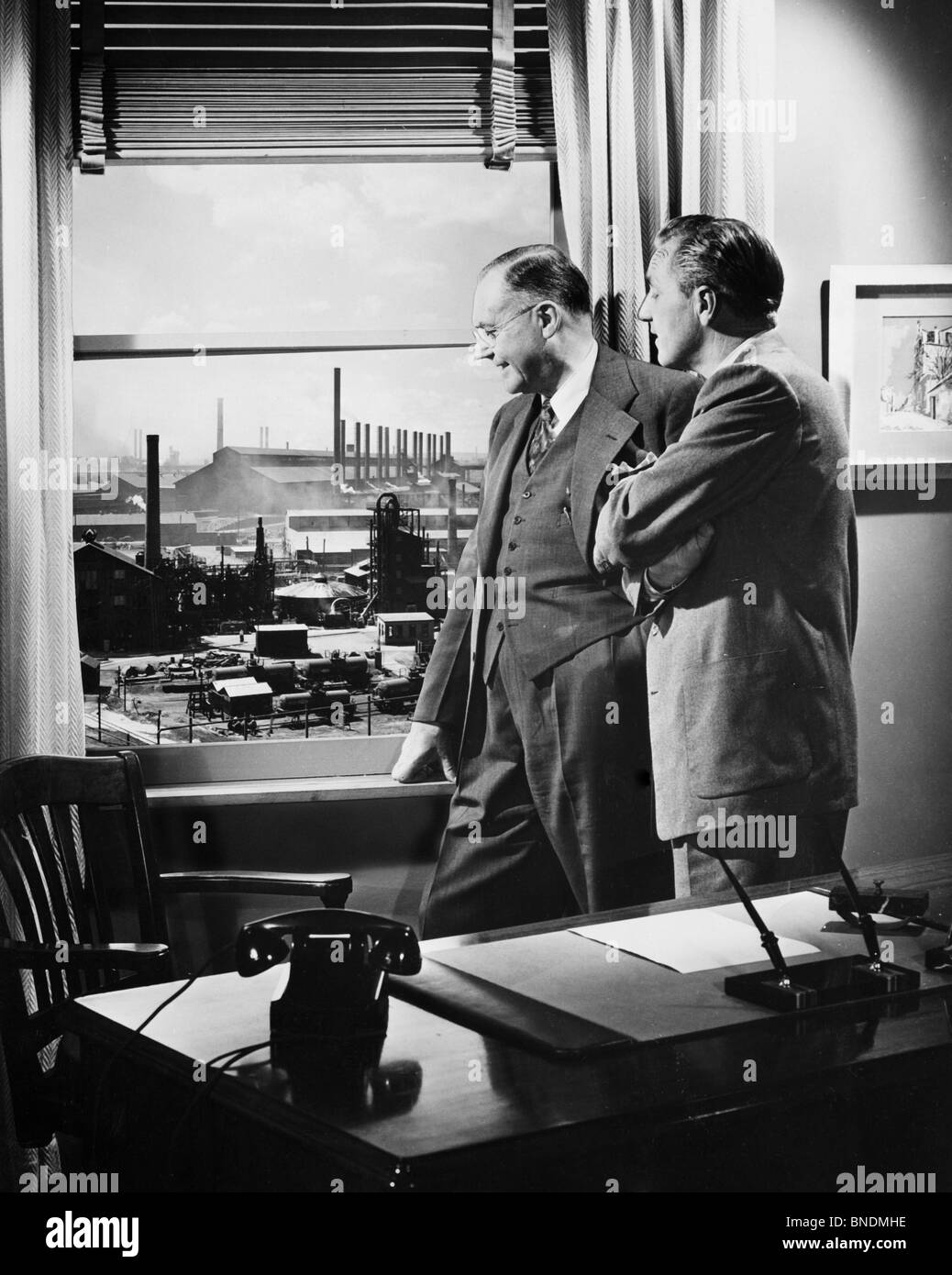 Side profile of two businessmen looking through a window Stock Photo ...