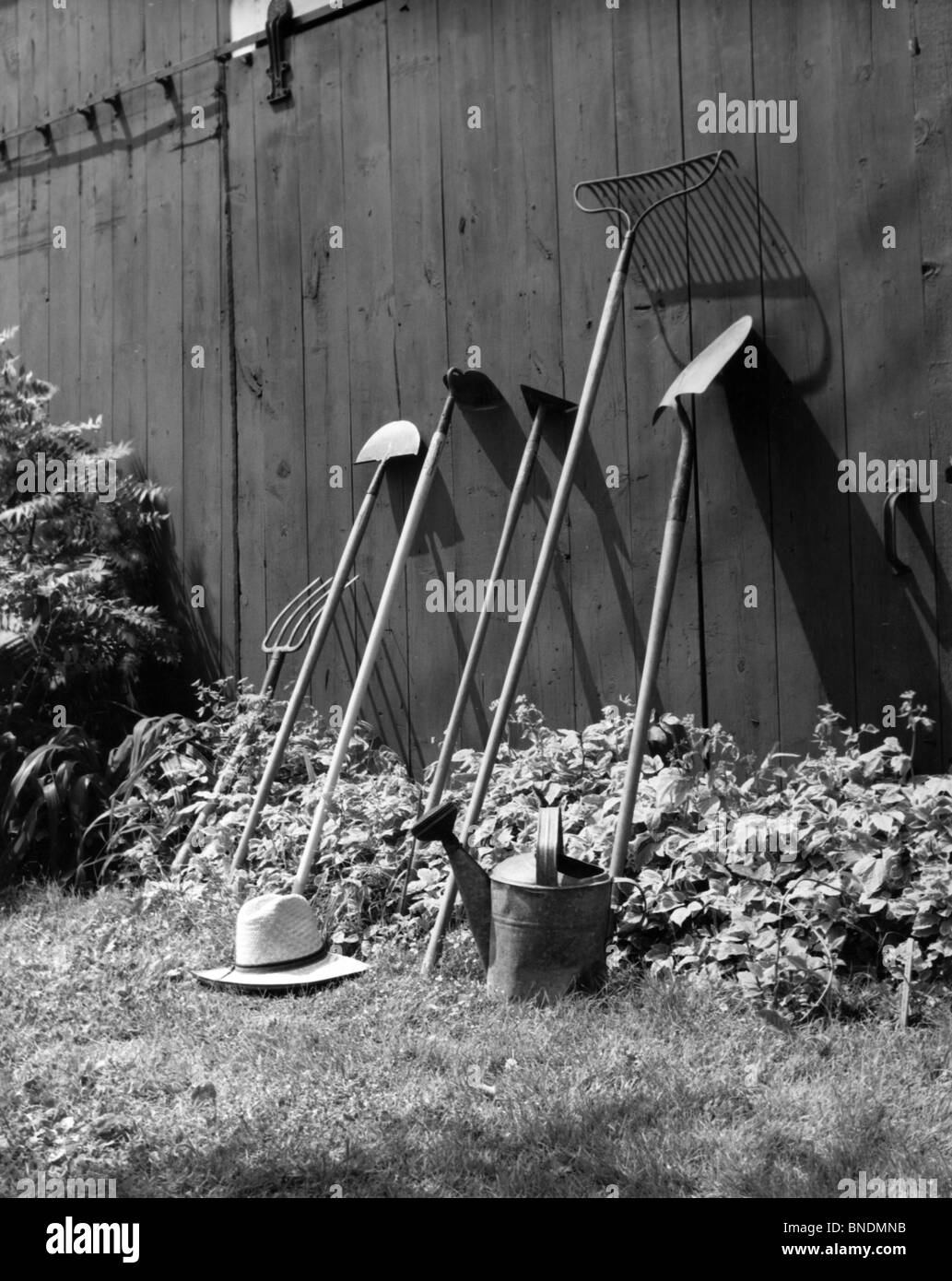 Gardening equipment leaning against a wall Stock Photo