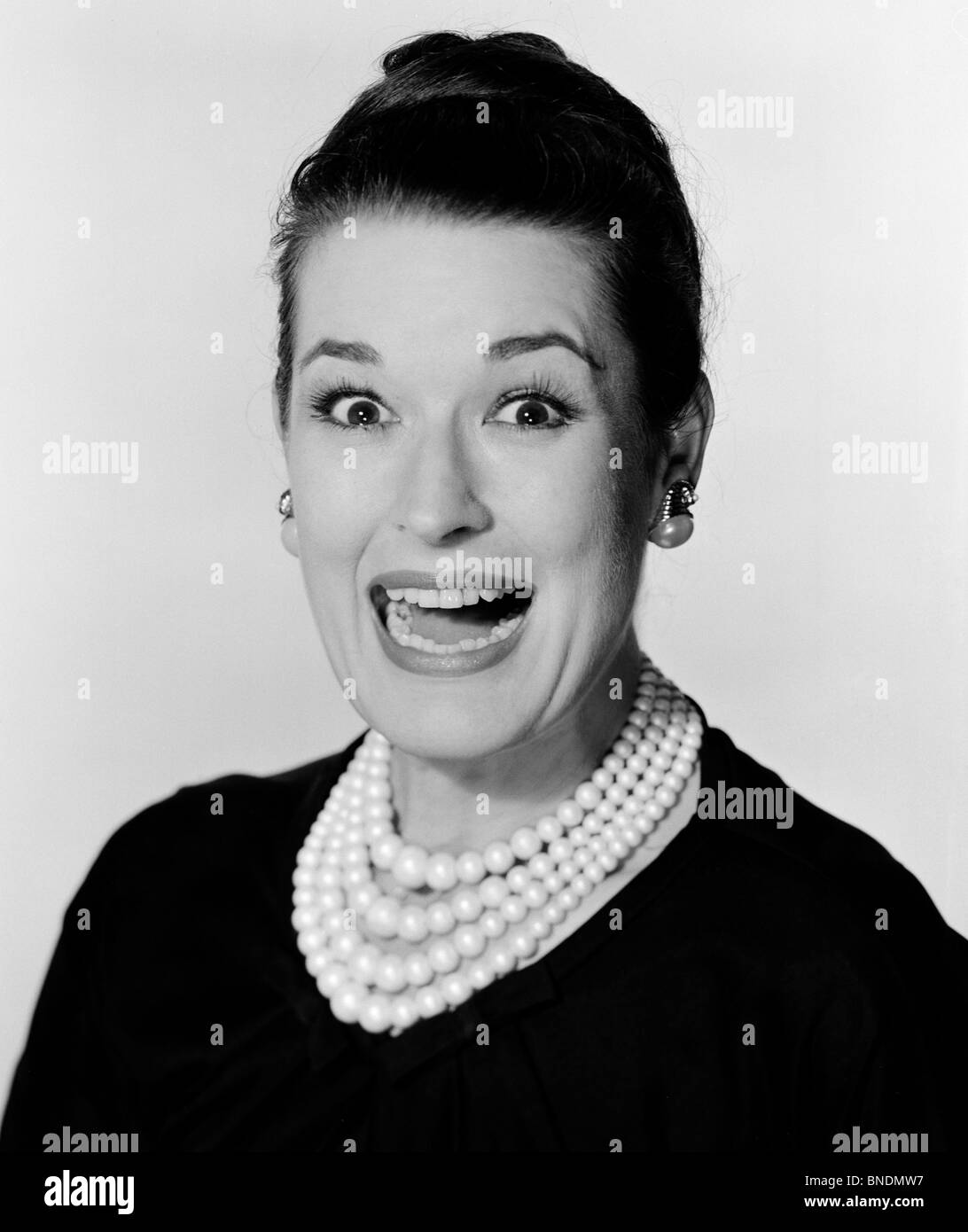 Portrait of a young woman looking surprised Stock Photo - Alamy