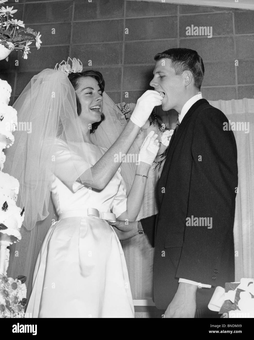 Bride feeding cake to groom Stock Photo