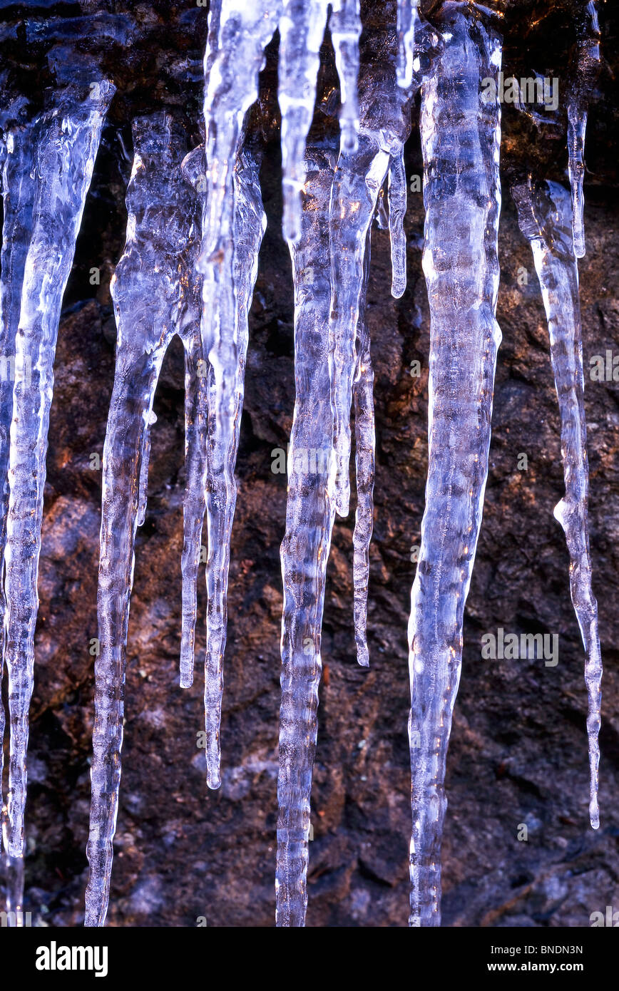 Cold winter scene of icicles against cold rocks Stock Photo - Alamy