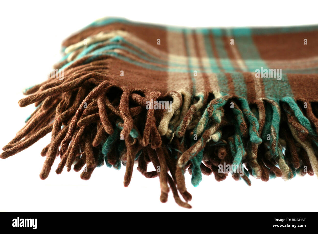 Brown-green checkered tartan wool blanket with fringe isolated on white Stock Photo