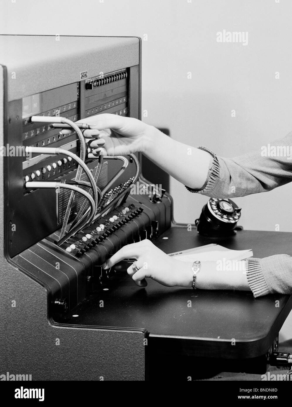 Close-up of a woman's hand operating a telephone switchboard Stock Photo