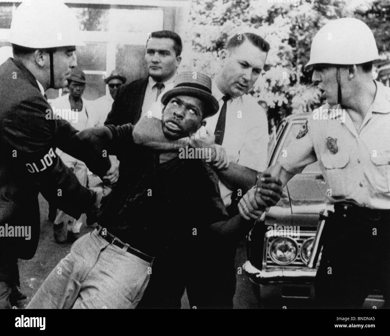 Police officer choking young man during arrest Stock Photo