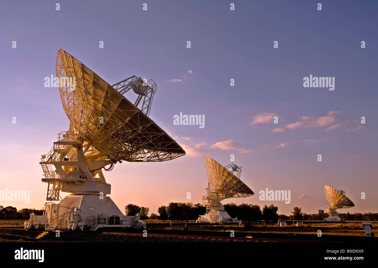 three radio telescopes photographed at sunset, Narrabri, NSW, Australia Stock Photo