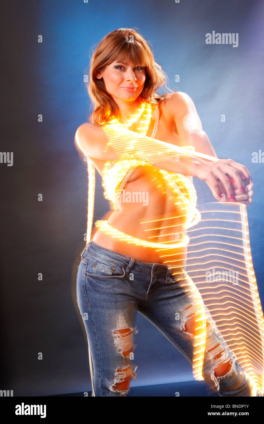 Cute blond dressed with light on blue shot so you could composite as grabbing and swinging your product Stock Photo
