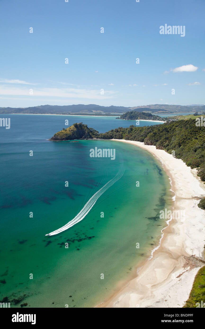 Speed Boat, New Chums Beach, Coromandel Peninsula, North Island, New Zealand - aerial Stock Photo