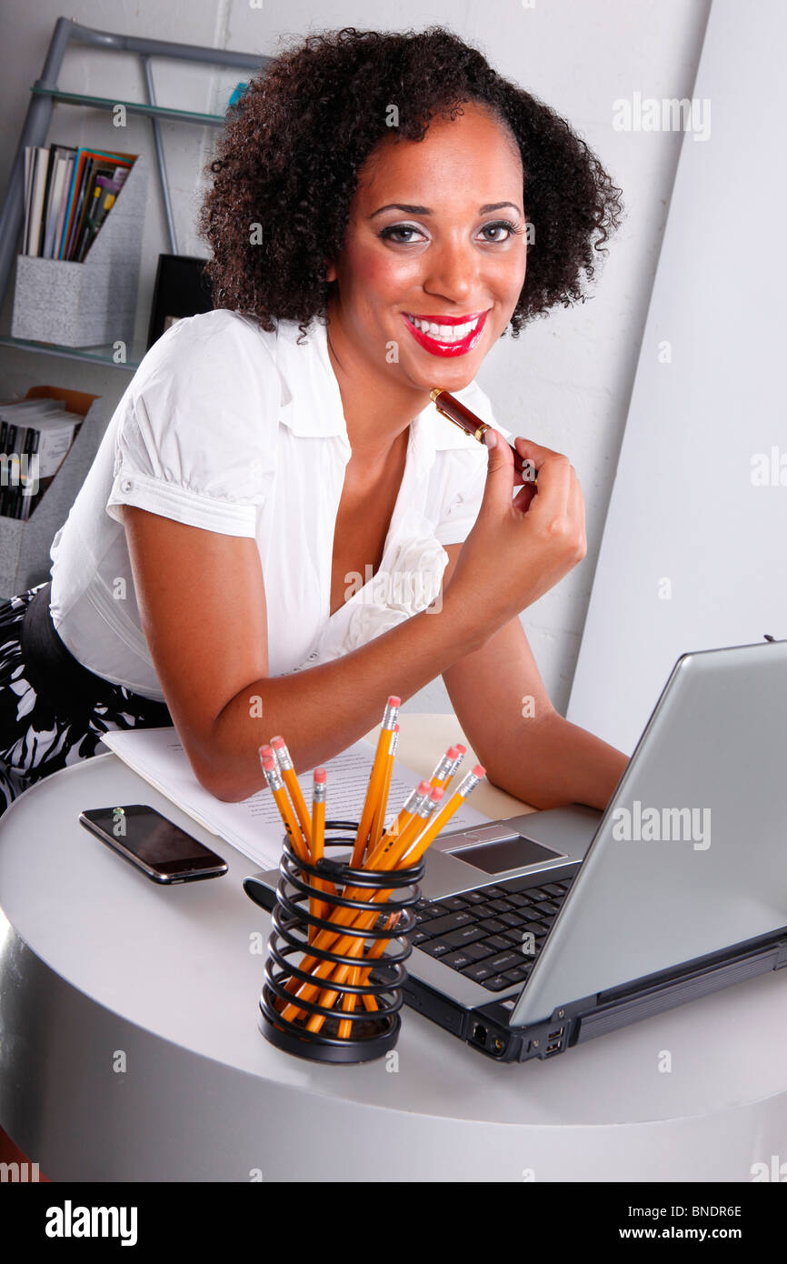 Real people at he office. Cute afro-latino on duty. Stock Photo