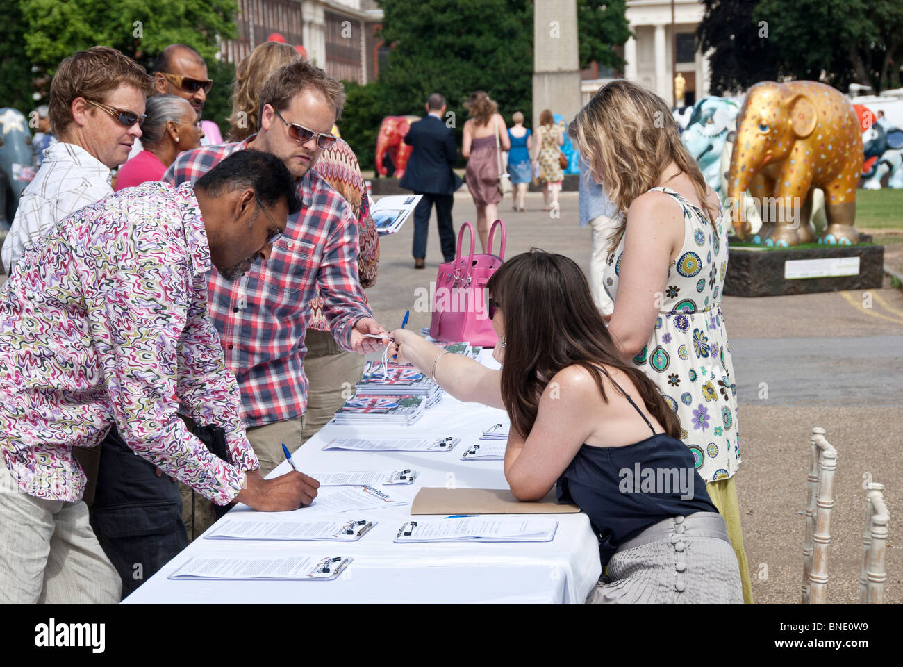 DURING THE CHARITY EVENT PUBLIC SIGNING THE SUPPORT DOCUMENTS Stock Photo